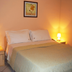 Roman Country Residence S.R.L. bedroom in Rome with double bed, bedside lamps and framed wall art