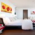 Laguna Palace Hotel Grado room with king bed, sofa seating, and balcony doors in Grado