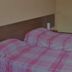 Albergo Trattoria dei Pani in Ventimiglia, room with two single beds made up in pink plaid bedding