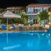 Samothraki Village Hotel in Samothraki with a lit outdoor pool, loungers and terrace seating