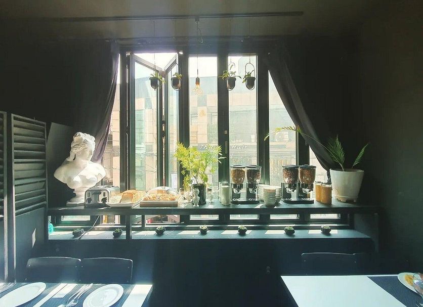 Friendly DH Naissance Hotel by Mindrum Group room with city-view window and plant display in Seoul