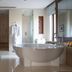 Jumeirah Dar Al Masyaf in Dubai bathroom with freestanding tub, walk-in shower, and double vanity