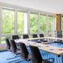 Hotel Döllnsee-Schorfheide meeting room in Templin with large windows overlooking green trees