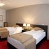 Homaris Corner Hotel Frankfurt Am Main guest room with two twin beds and bedside lamps in Frankfurt am Main