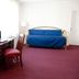 Windsor Park hotel room in Washington, D.C. with desk, chair, blue sofa bed and floor lamp