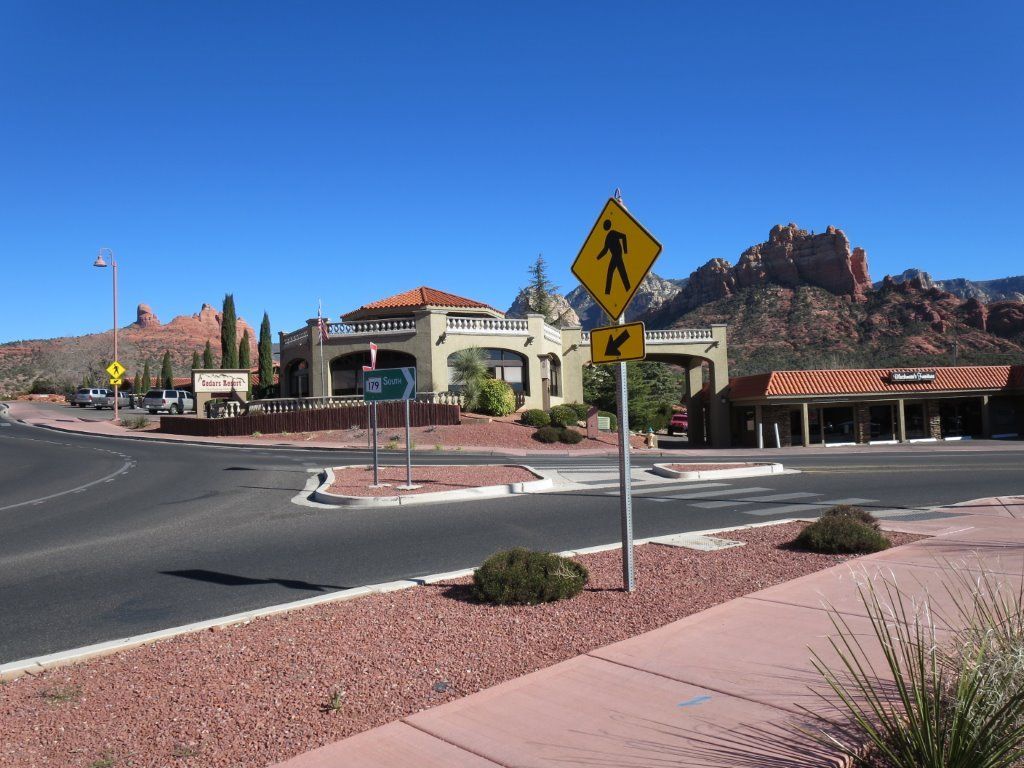 Cedars Resort in Sedona with a courtyard-style building and red rock backdrop beside a road