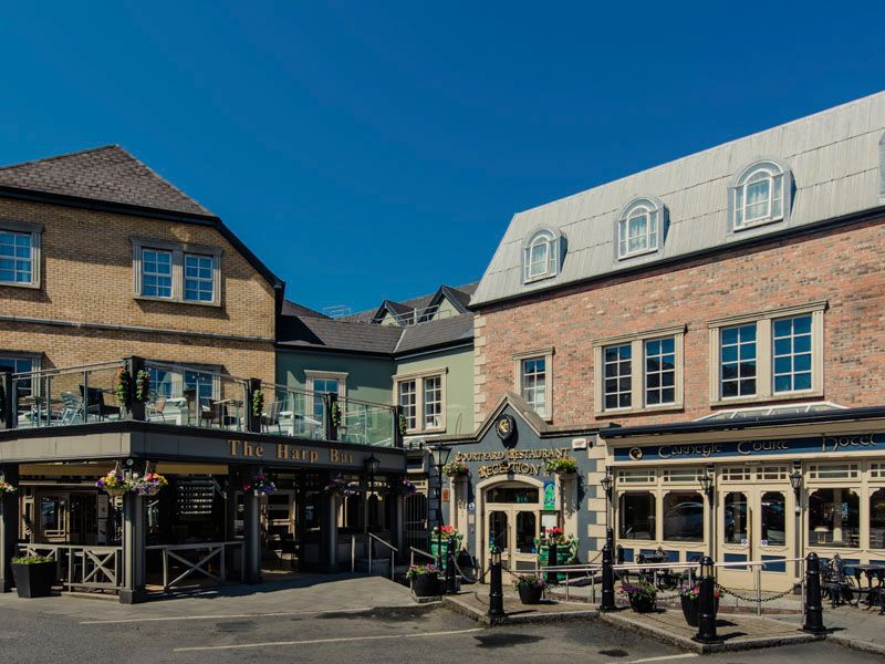 Carnegie Court in Swords exterior with brick buildings, balconies, and a pub-style entrance