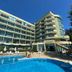 Palm Beach Hotel in Golden Sands with curved outdoor pool and modern beachfront facade