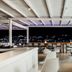 Mykonos Essence Adults Only in Mykonos terrace with seating and city lights at night
