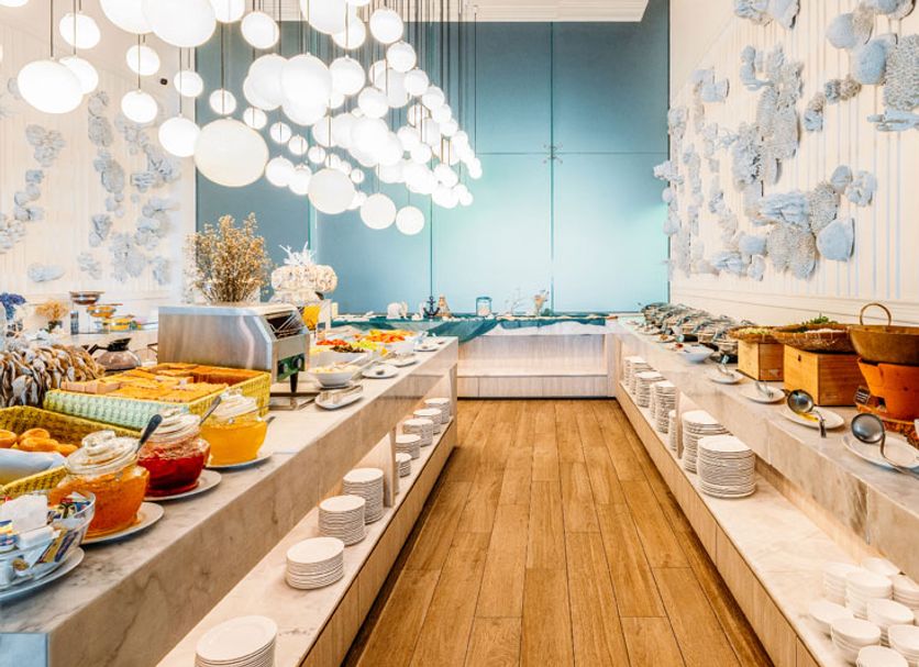 Hotel Tide Phuket in Ratsada buffet breakfast spread with hanging globe lights and blue accent wall