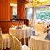 Goodview Hotel Sangem Qiaotou in Dongguan: elegant dining room with round tables and large forest views