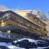 Hotel Primula in Abetone, snowy alpine hotel exterior with parked cars and frosted trees