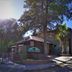 Ayres Del Bosque in Villa de Merlo, roadside hotel entrance with trees and mountain backdrop