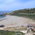 Oasis Scaleta Hotel in Skaleta overlooking a sandy beach with sunbeds, turquoise sea and rocky coast