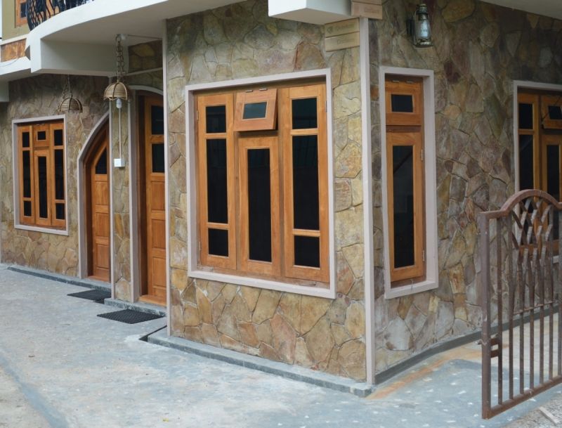 Quinton Enclave in Shillong exterior with stone facade, wooden windows and entrance