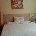 Hanting Express Kunshan Bailu Middle Road room with a bed and bedside table in Suzhou