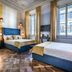 Arte' Boutique Hotel Florence room with two beds, ornate ceiling, and tall windows