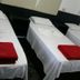 Hotel Anápolis in Anápolis: three single beds with white linens and red towels in a simple room
