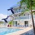 Spray Beach Oceanfront Hotel in Spray Beach with outdoor pool, palm trees and oceanfront balconies