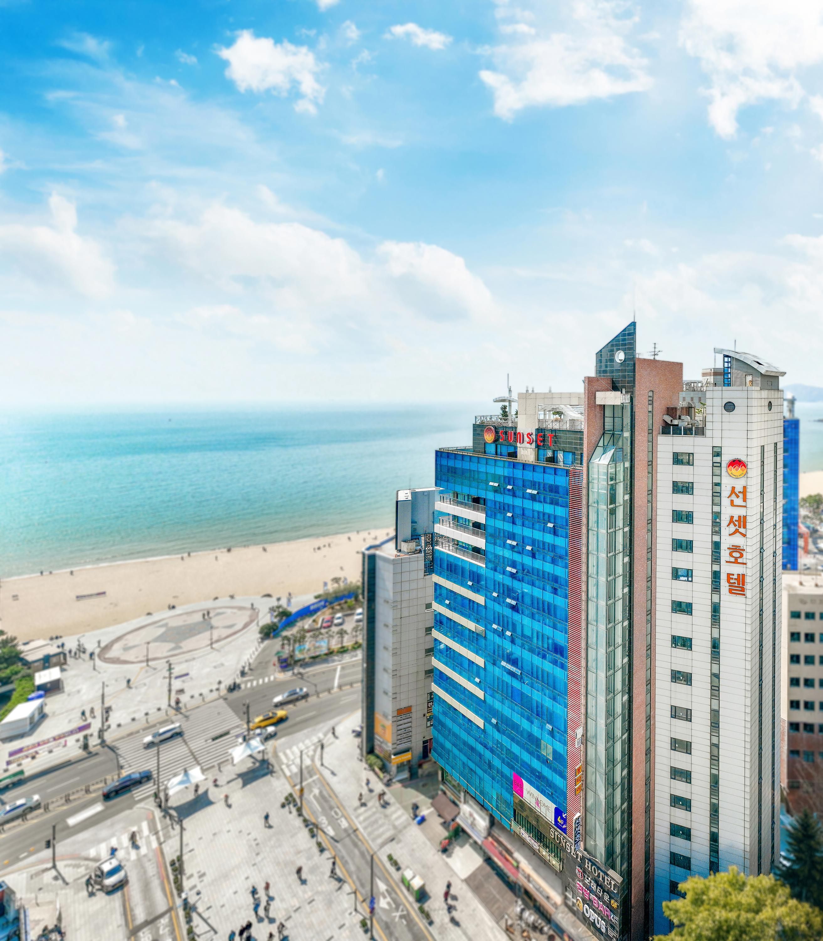 Sunset Hotel in Busan with oceanfront views, beach, and high-rise buildings along the coast