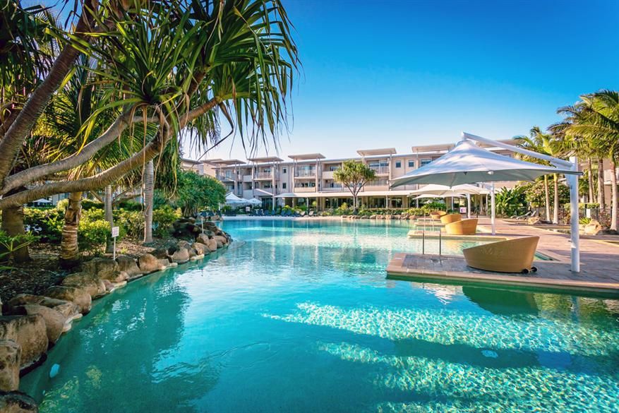 Peppers Salt Resort & Spa Kingscliff pool with tropical landscaping and shaded cabana