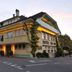 Hôtel Restaurant Cave Bel-Air in Mont-Vully, exterior of a charming two-story hotel at dusk