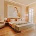 Kaiserhof Victoria in Bad Kissingen: bright hotel room with twin beds, armchair, large artwork and balcony door