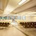 Garden Toscana Resort in San Vincenzo banquet hall with rows of chairs and bright ceiling lights