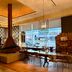BREEV GWANGJU by LOTTE HOTELS lobby lounge in Gwangju with fireplace, dining tables, and city views
