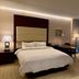 BREEV GWANGJU by LOTTE HOTELS guest room with king bed, desk, chair, sofa, and floor-to-ceiling curtains in Gwangju