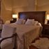 Villa Vicuña Wine & Boutique Hotel in Cafayate guest room with king bed, armchairs and bedside lamps