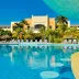 Iberostar Waves Rose Hall Beach in Montego Bay with a large outdoor pool and palm trees