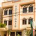 Hotel Maju in Rio Branco exterior with parked cars and balcony-style windows