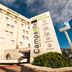 Campanile Prime - Nice Airport hotel exterior in Nice with tall sign and blue sky