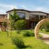 Sommer Residence Hotel&Spa in Kluczbork with a stone archway and landscaped garden outside the hotel