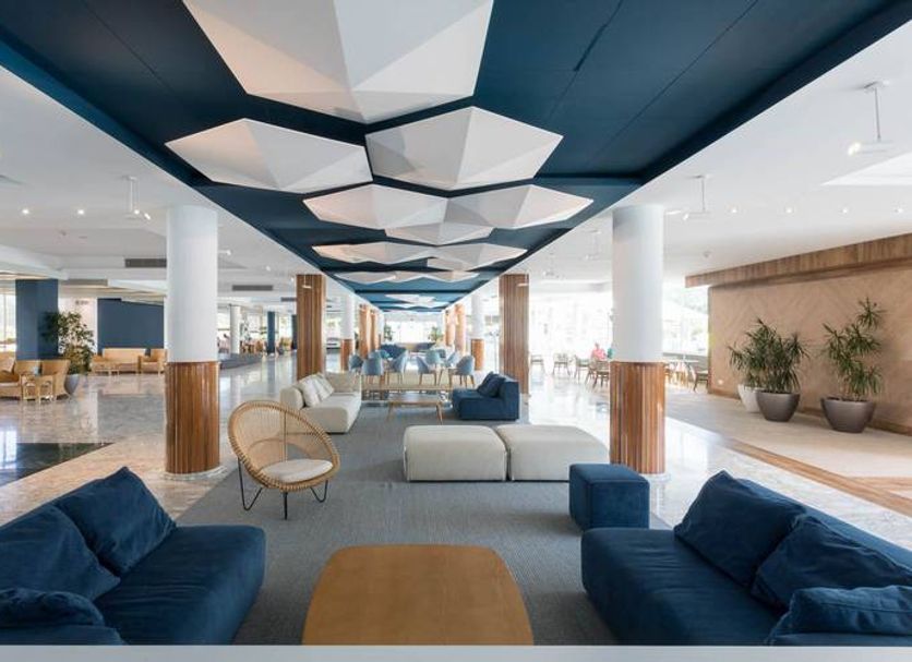 Alegria Caprici Verd in Santa Susanna lobby lounge with blue sofas, lounge chairs and geometric ceiling