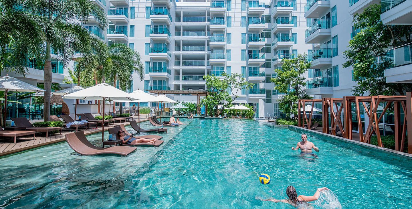 Fishermen's Harbour Urban Resort in Patong with a large outdoor pool and sun loungers