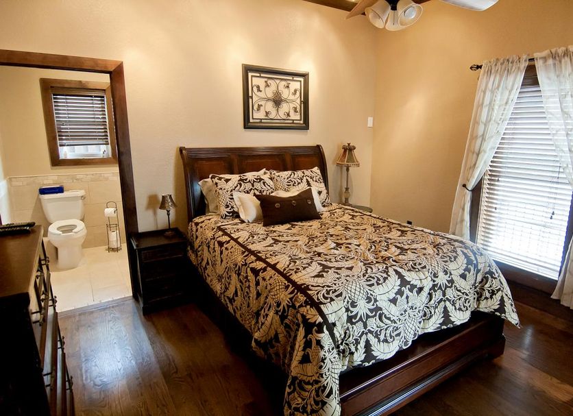 The Thornton Inn Bed and Breakfast in Arlington, bedroom with patterned bedspread, bathroom doorway, and window