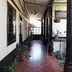 Casa Seibel hallway in Quetzaltenango with tiled floor, hanging light, and potted plants