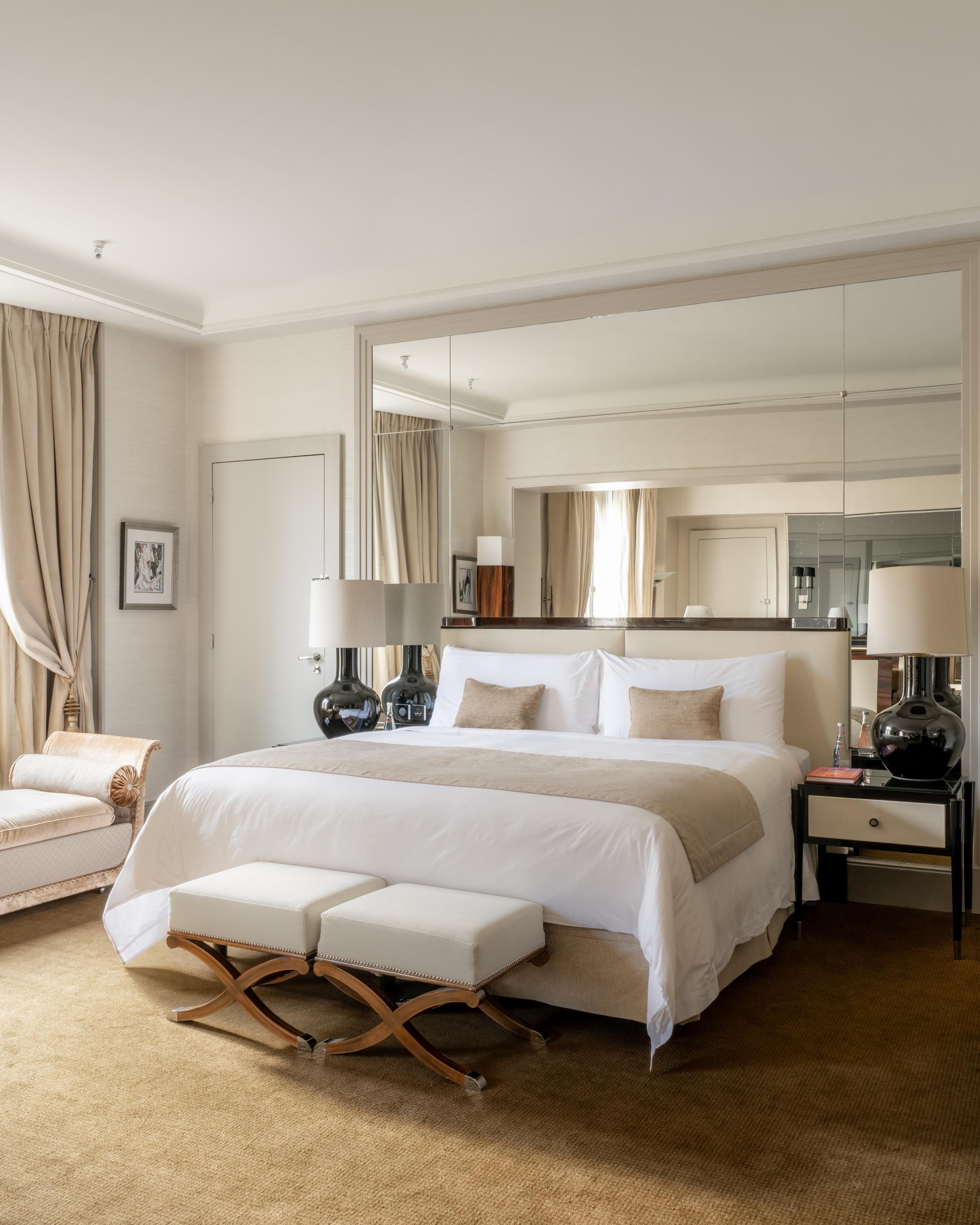 Prince de Galles, a Luxury Collection Hotel, Paris bedroom with king bed, bench, and mirrored wall