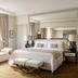 Prince de Galles, a Luxury Collection Hotel, Paris bedroom with king bed, bench, and mirrored wall