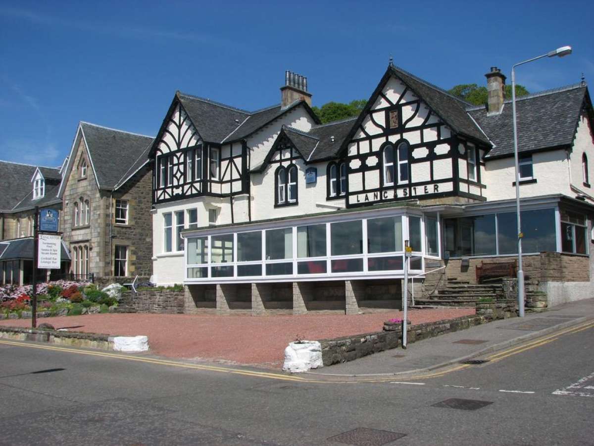 Lancaster Hotel in Oban, Tudor-style exterior with large windows on a sloped street