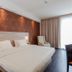 Star G Hotel Premium München Domagkstraße room with king bed, desk and chair, and floor-to-ceiling window in Munich
