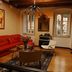 Celenga Apartments in Dubrovnik living room with red sofa, coffee table, windows, and wall-mounted TV