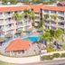 Casa Del Mar Beach Resort in Oranjestad with a central pool, palm trees, and red-roofed balconies