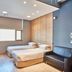 Provista Hotel Gangnam in Seoul guest room with two single beds and a black sofa
