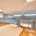Provista Hotel Gangnam in Seoul loft-style room with low bed and glass railing overlooking lower level