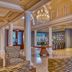 Trianon Bonita Bay Hotel lobby in Bonita Springs with chandelier, columns, and wicker seating