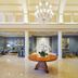 Trianon Bonita Bay Hotel lobby in Bonita Springs with chandelier, columns, and round table