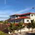 Pousada Real in Ilha Comprida, a low-rise hotel with red roofs and palm trees outside